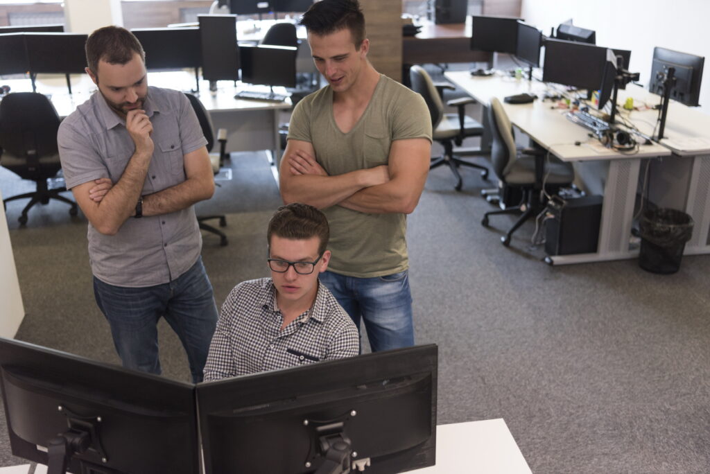 Diverse IT team working on software development in a tech office.