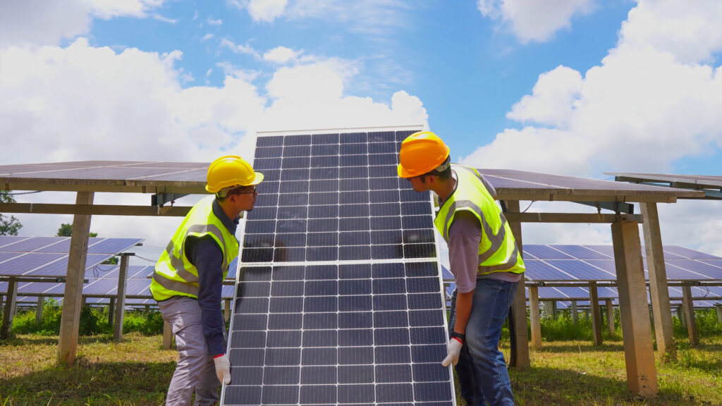 Workers installing solar panels on a rooftop